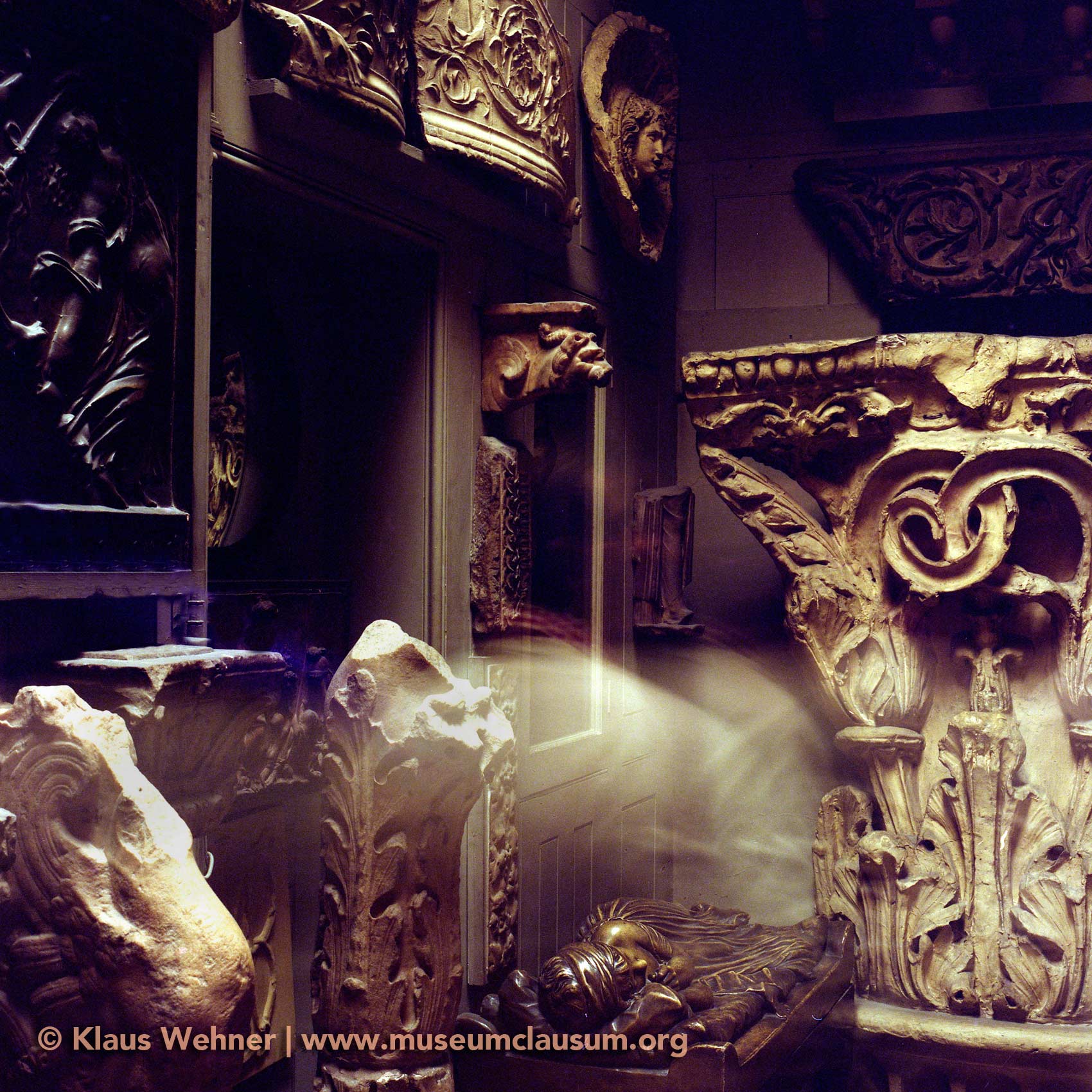 Sir John Soane's Museum: Fragments in the Museum Corridor with motion blur of a visitor.
